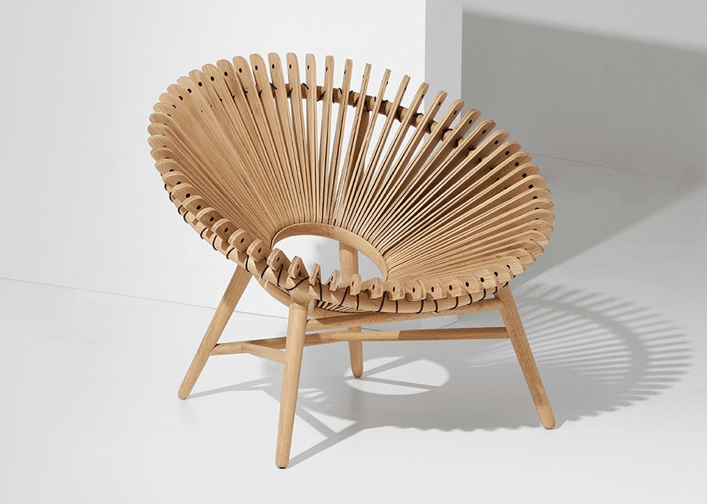 An iris lounge oak chair with a unique circular wooden slat design, set against a minimalist white background.