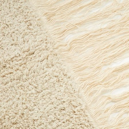 A close-up view of a Moroccan Kaarol rug, showcasing its soft, textured surface and fringe detail.