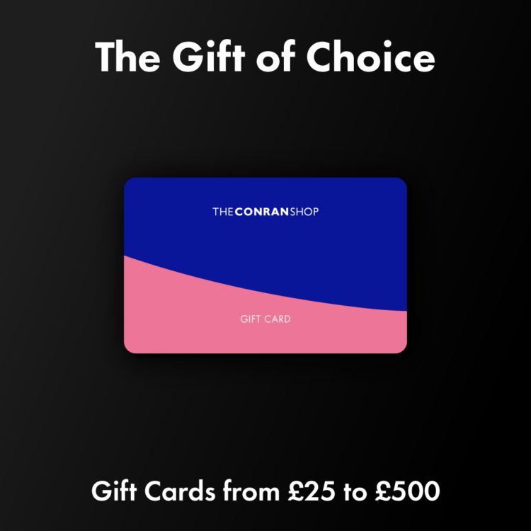 An image of a gift card from The Conran Shop, with a bold blue and pink design, displayed against a dark background. The text above reads 