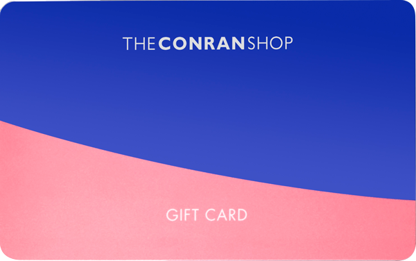 A vibrant gift card from The Conran Shop featuring a bold blue top half and a pink bottom half with a curved dividing line.