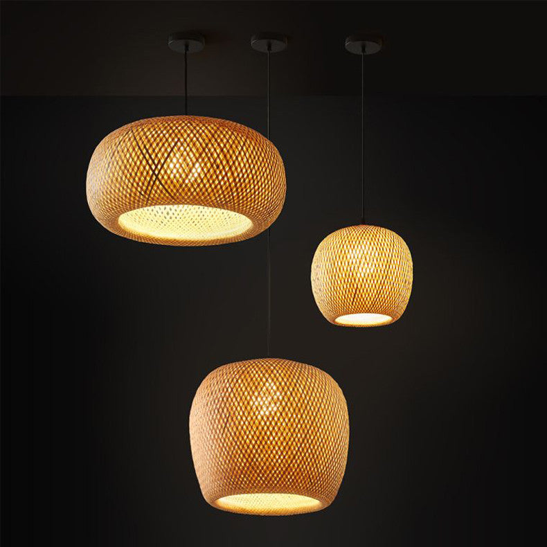 Three Hatch Bamboo Shades hanging from the ceiling, illuminated and casting a warm glow.